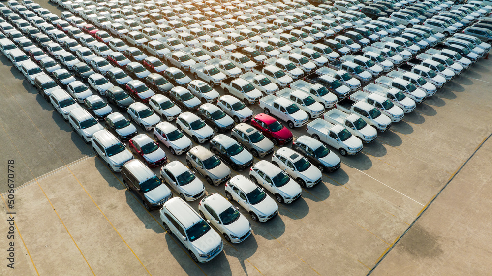 Aerial view a lot of new car for import and export shipping by ship; Smart dealership at car depot; 