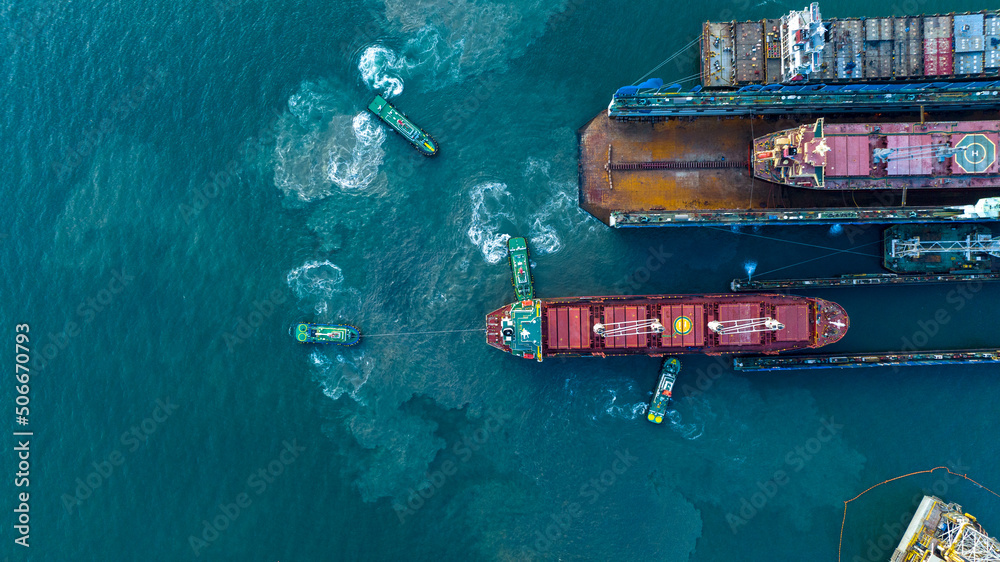 Tug boat drag pull cargo ship from dry dock concept maintenance service