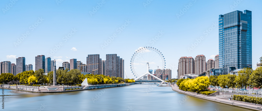 Sunny day scenery of Haihe River and Ferris wheel in Tianjin, China