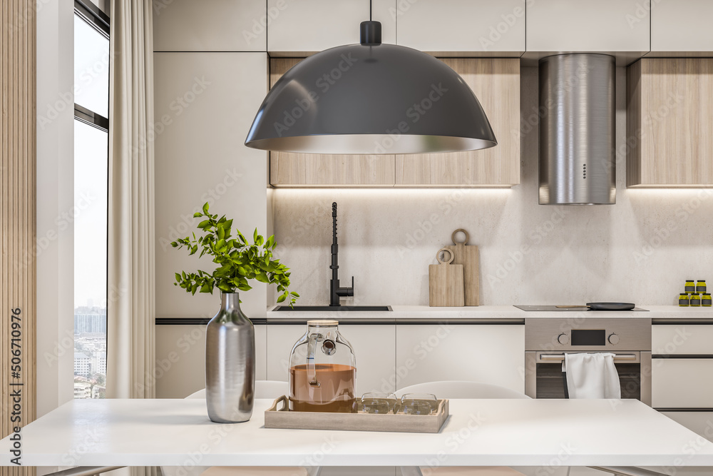 Front view on modern eco interior kitchen area with white kitchen set, modern metallic lamp above wh