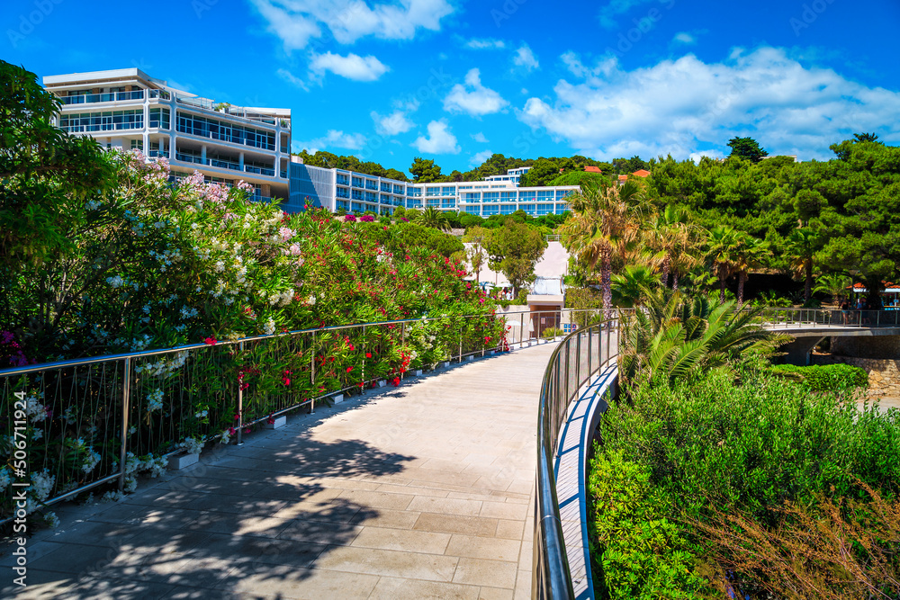 Flowery promenade and beach hotels in Hvar island, Dalmatia, Croatia