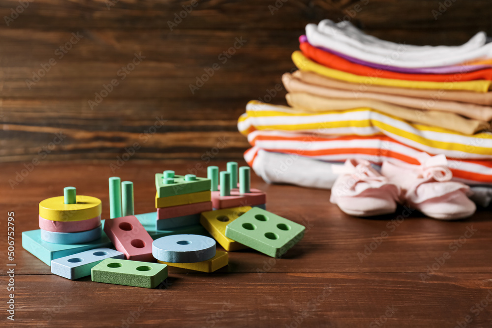 Children building blocks on dark wooden background