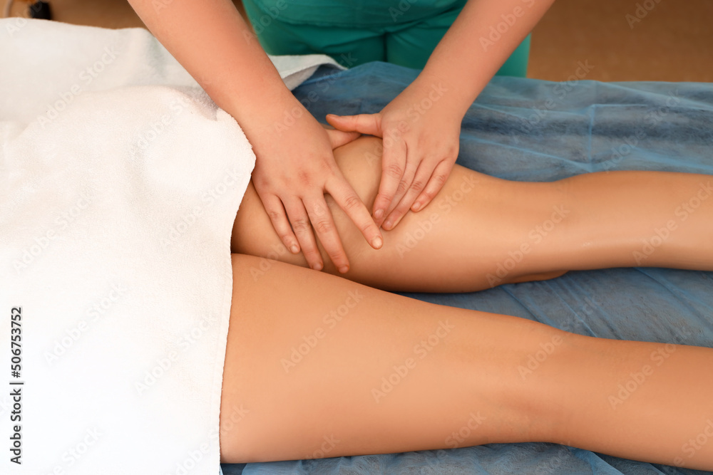 Young woman having anti-cellulite massage in beauty salon