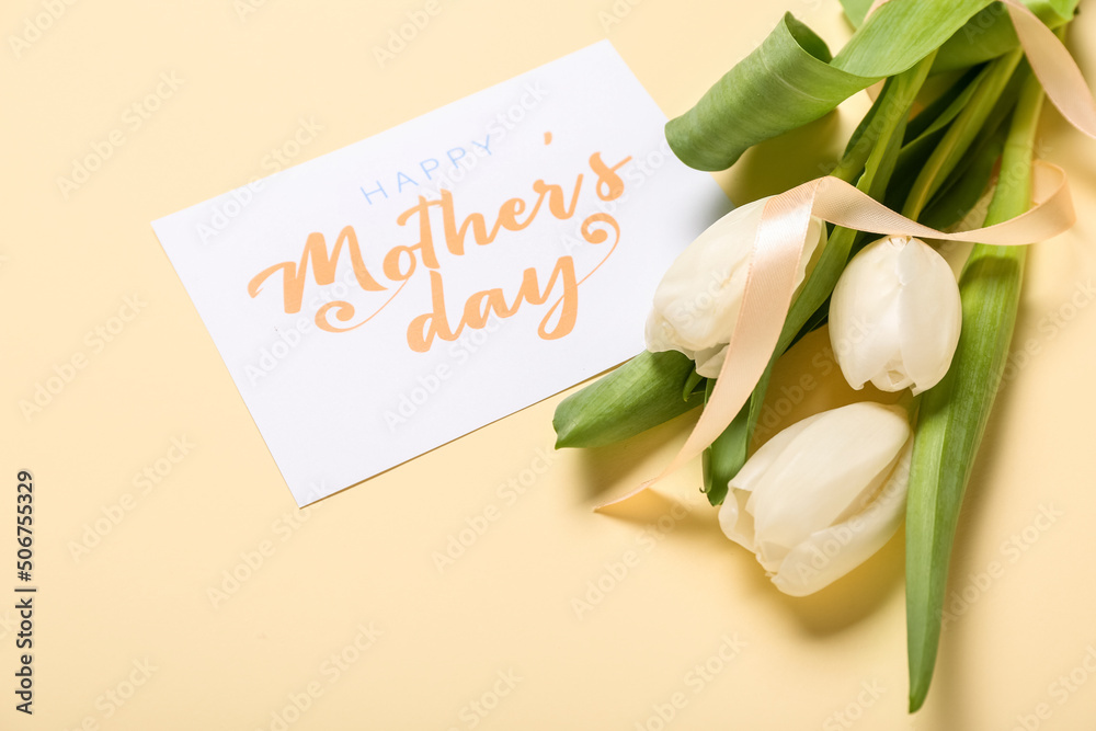 Card with text HAPPY MOTHERS DAY, white tulips and ribbon on beige background