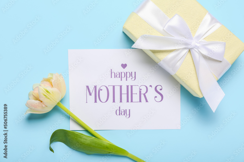 Card with text HAPPY MOTHERS DAY, flower and gift box on blue background