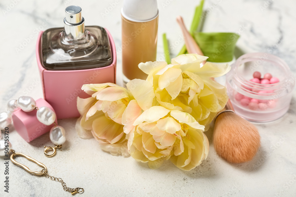 Bouquet of beautiful tulips and female accessories on light background