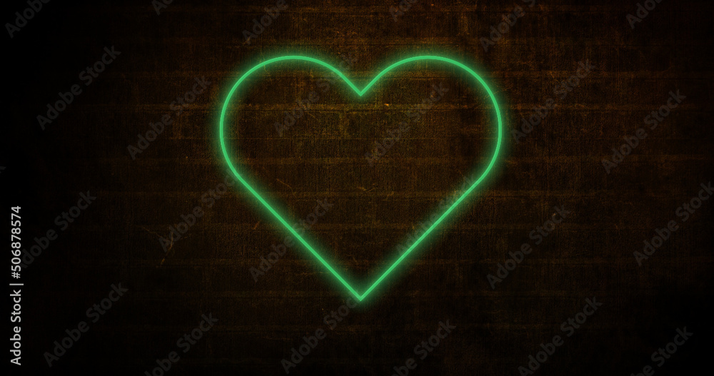 Image of glowing neon heart icon on brick wall