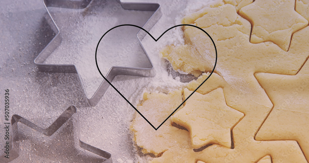 Image of neon heart over cookies dough and mold