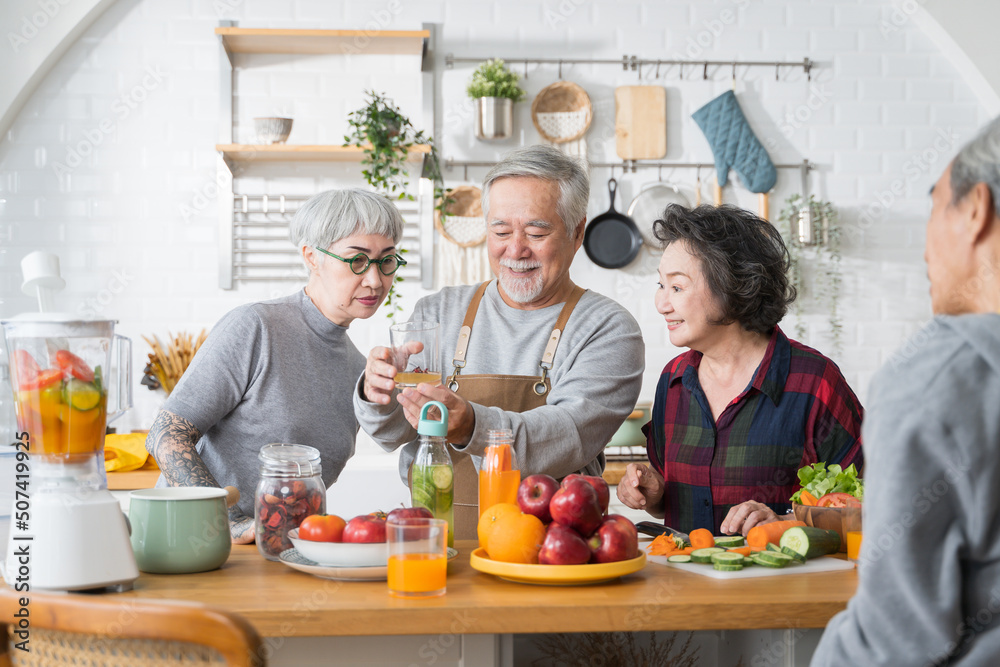 Group of Asian senior people friends making fruit juices for friends to drink in kitchen.colorful fr