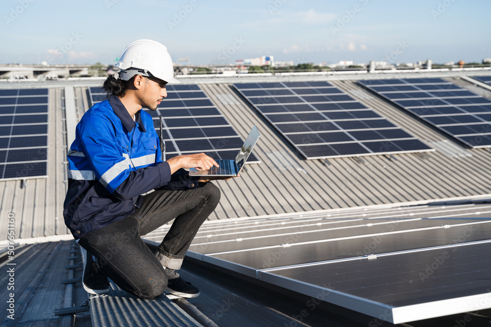 Asian technician installing inspection or repair solar cell panels on background field of photovolta