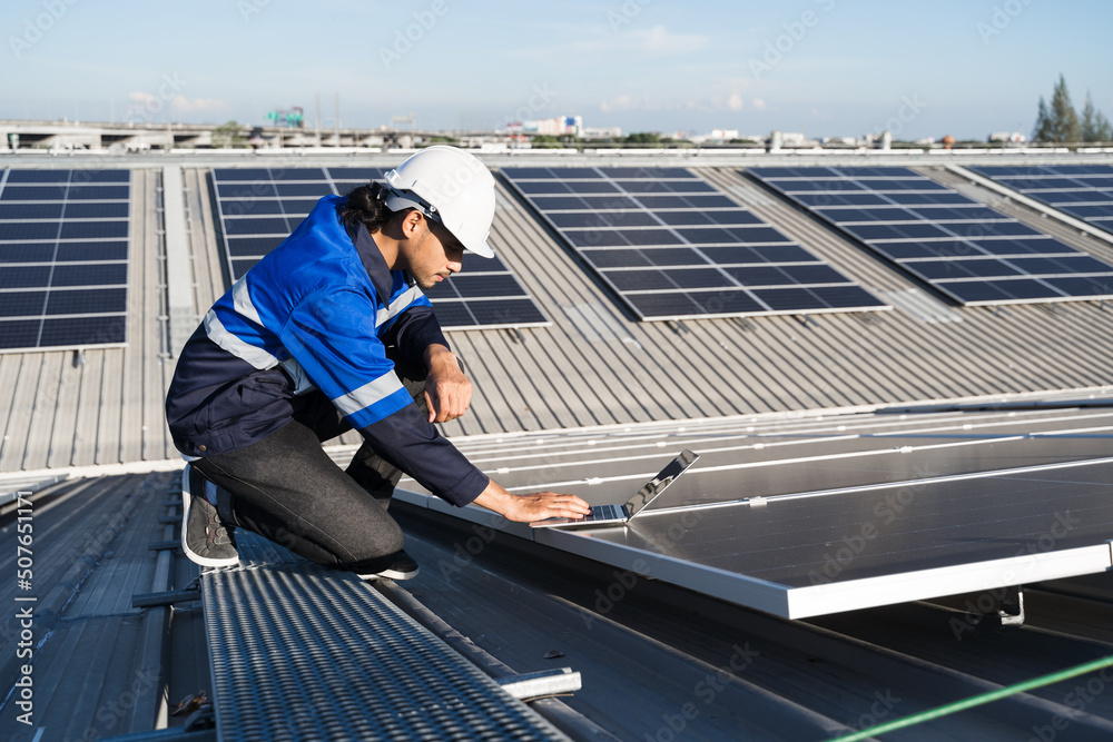 Asian technician installing inspection or repair solar cell panels on background field of photovolta