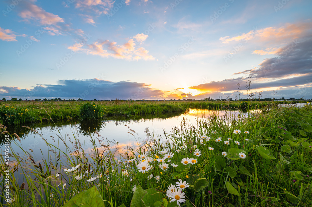 The sun sets over the Dutch polder landscape near Gouda, Holland