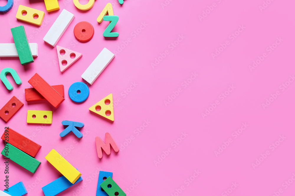 Children building blocks with letters on pink background