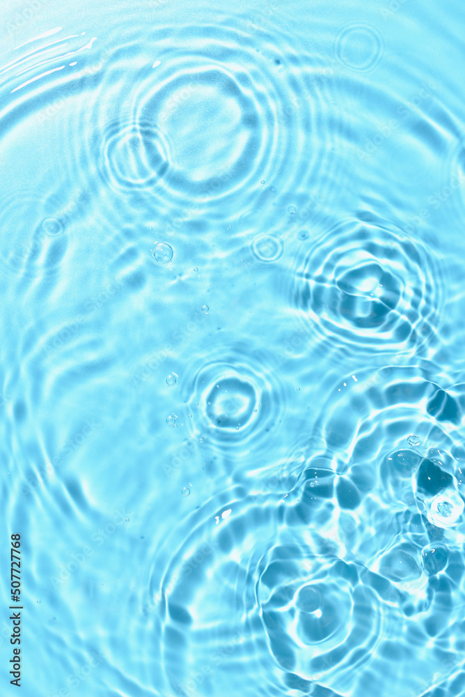 Texture of water with ripples on blue background, closeup