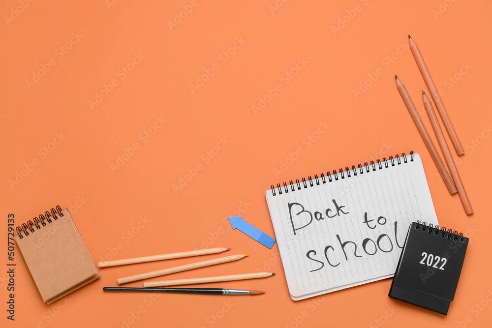 Stationery supplies with text BACK TO SCHOOL on orange background