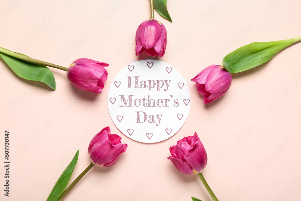 Card with text HAPPY MOTHERS DAY and tulips on pink background