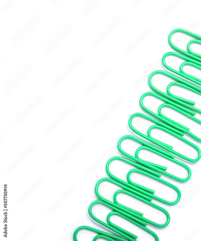 Green paper clips on white background