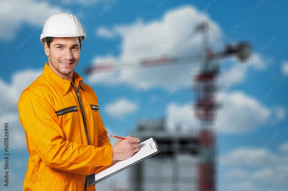 Engineer or architect with building plan at construction site, business, building, industry, people 