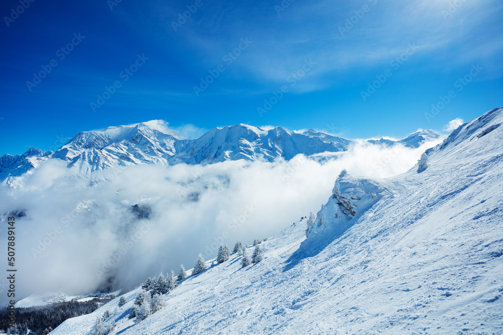 View of the Mont Blanc massif mountain range over clouds