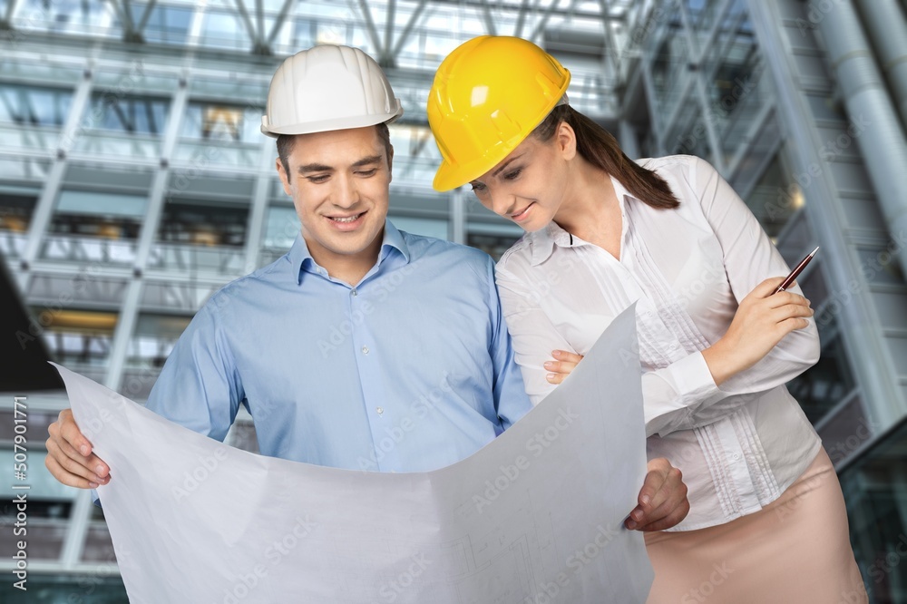 Manual worker and engineer discussing on plan.  Architect supervisor meeting at construction site.