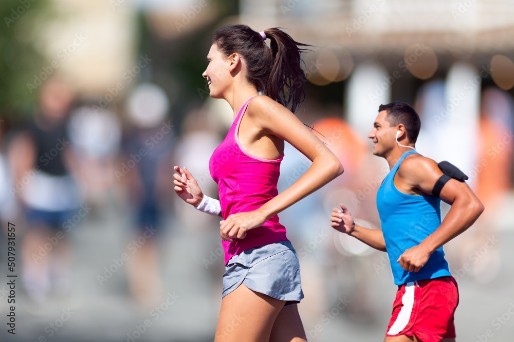 People sport running concept. Happy runner couple exercising outside as part of healthy lifestyle.