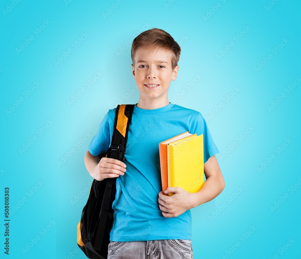 Cute little child with school bag and holds a book.