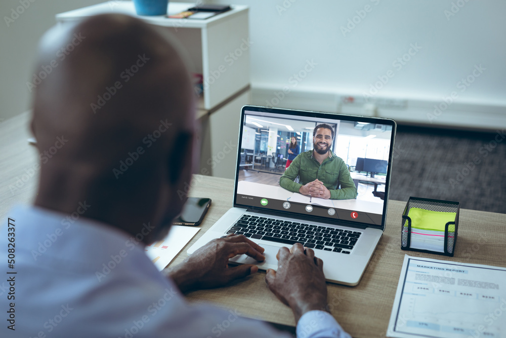 African american businessmen having online meeting though laptop in office