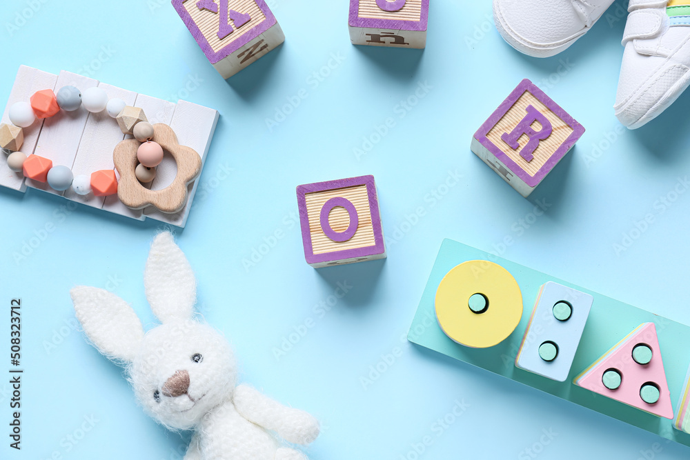 Children toys with booties on blue background