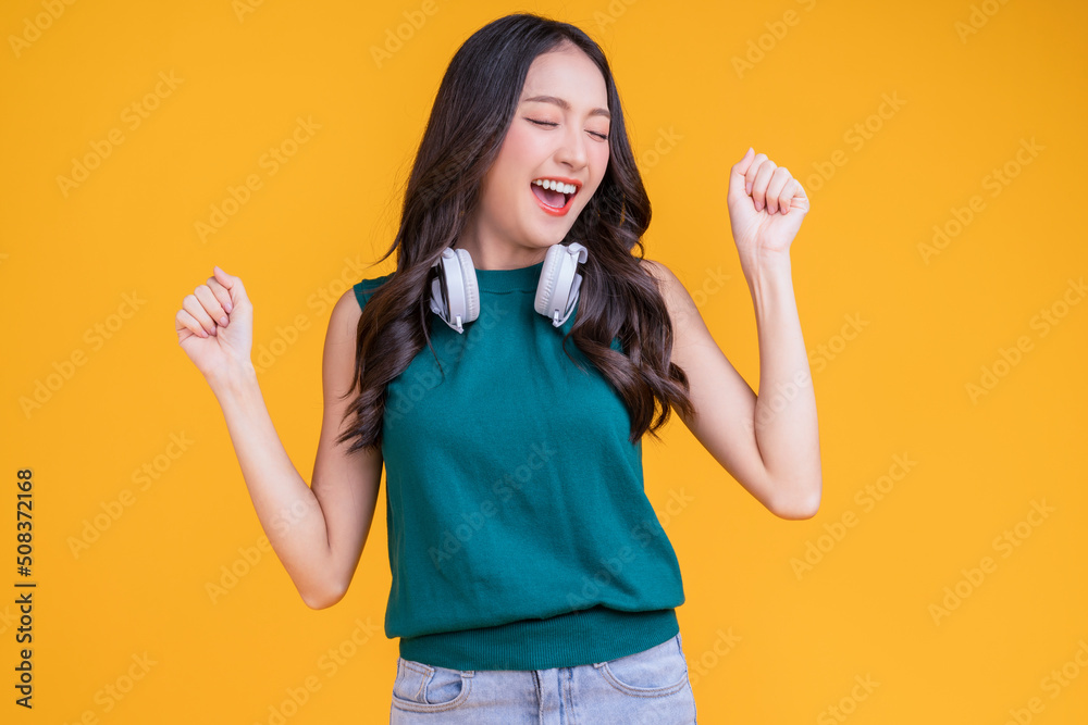 happiness carefree asian female woman teen wearing headphone listen dance joyful fun moving moment ,