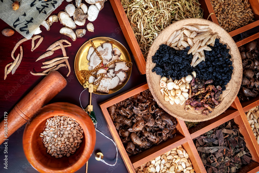 Chinese herbal medicine and flower tea on wooden