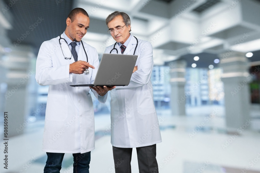 Beautiful couple doctors on hospital background