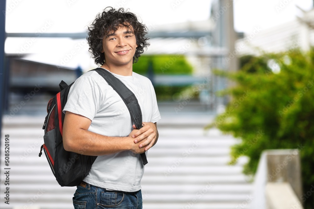 Happy young student at the university background