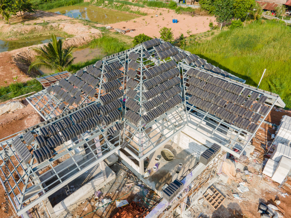 Aerial view of Concrete or CPAC cement roof tiles on the new roof are under construction. residentia