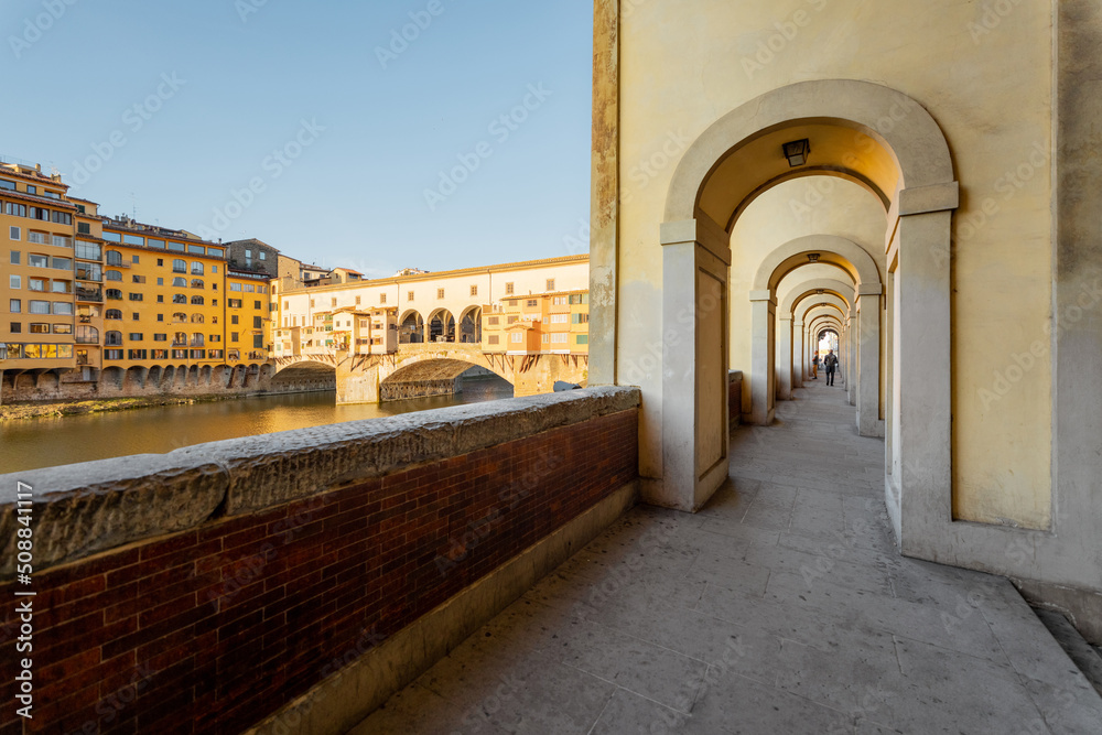 Morning view on famous Old bridge called Ponte Vecchio and arcade on Arno river in Florence, Italy. 