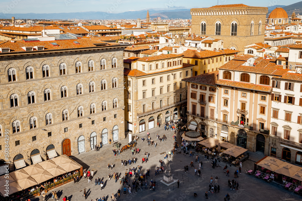 Top view on crowded Signoria square near Vecchio palace on a sunny day in Florence, Italy. Cityscape