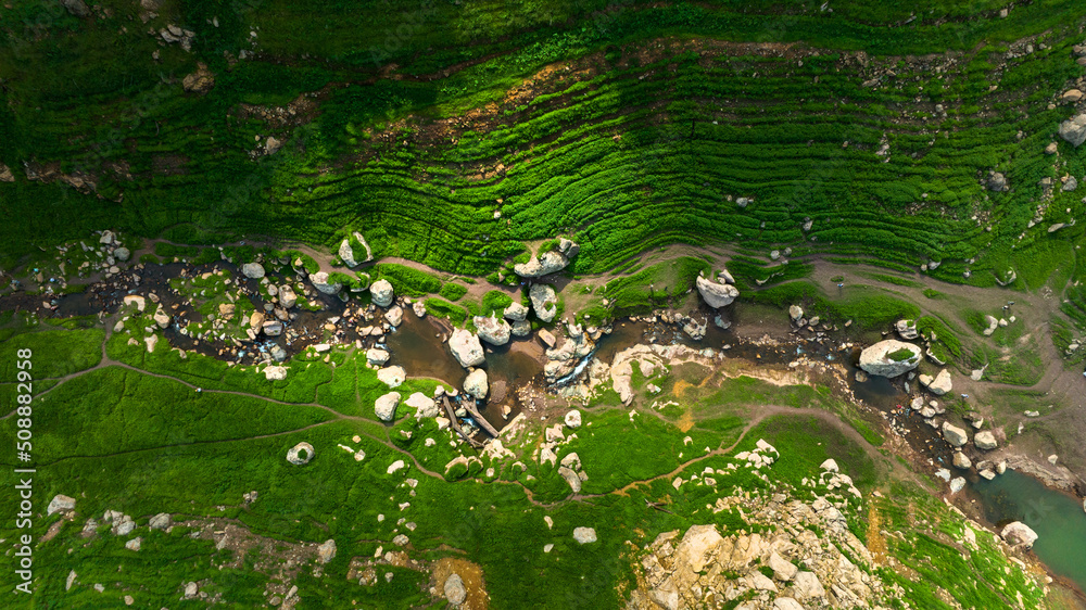 野生森林山上美丽的天然溪流和绿色的草地鸟瞰图