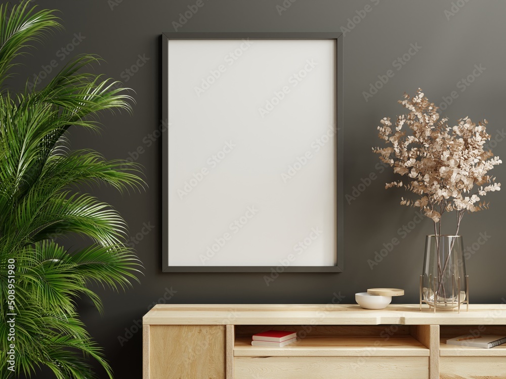 Mockup frame on wood cabinet in living room interior on empty dark wall background.