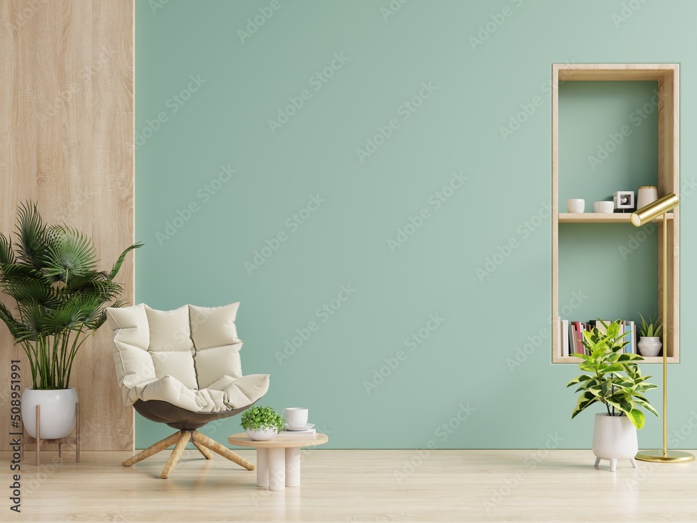 Living Room with cream color fabric armchair and plants on empty green wall background.