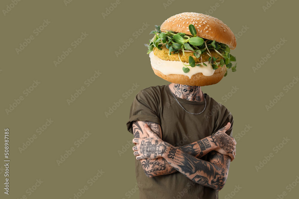 Tattooed man with tasty burger instead of his head on color background