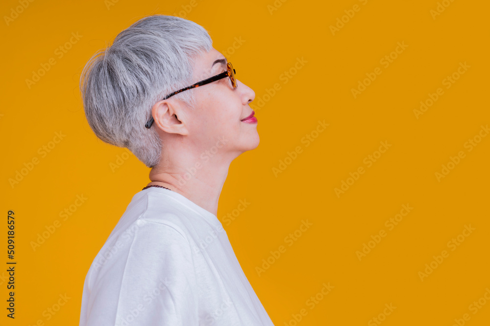 side view portrait asian old woman tattoo grey hair positive smile cheerful face expression looking 