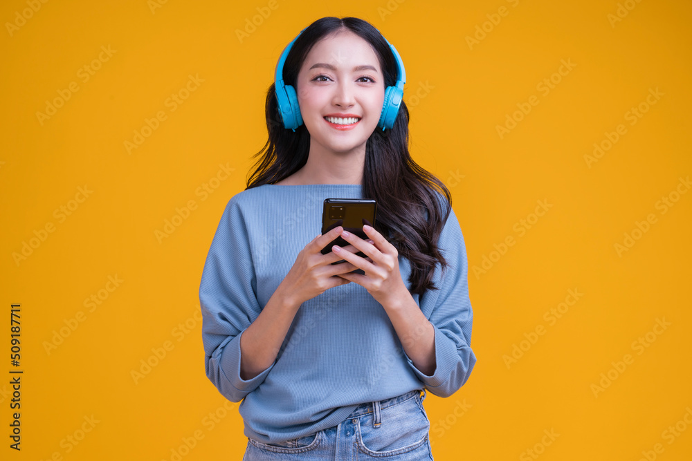 happiness carefree asian young female woman teen wearing headphone smartphone listen music joyful fu