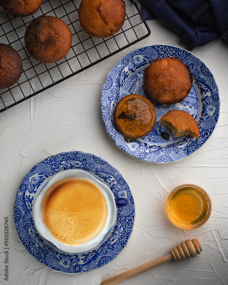 Muffins with raisins served with coffee and honey for restaurant on white background.Top view