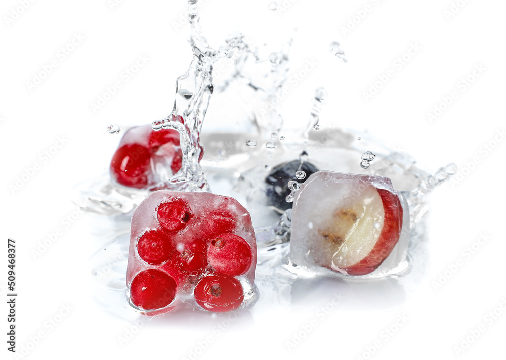 Fresh berries frozen in ice with splash of water on white background