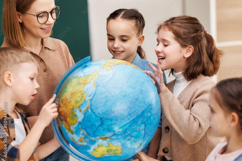 Teacher and kids during geography lesson