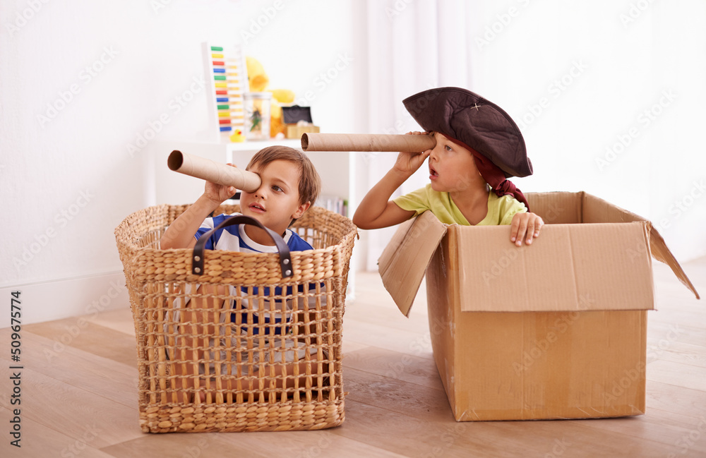 Whats that over there. Shot of two little boys pretending to be pirates in their bedroom.