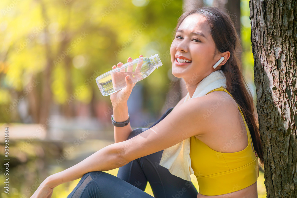 年轻女性饮用瓶装水亚洲女性锻炼或运动后饮用水。美丽