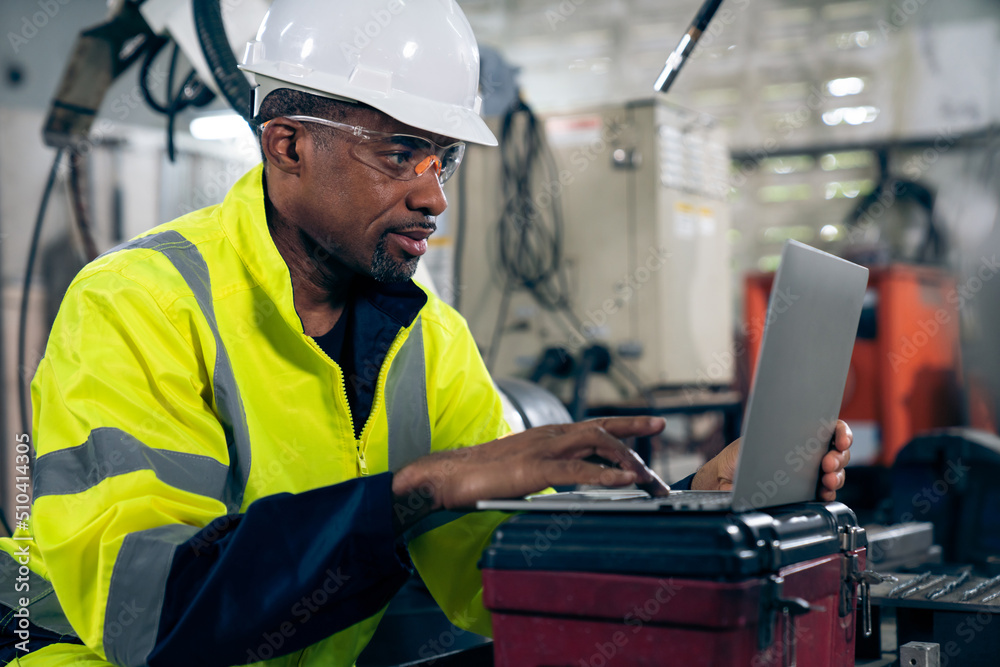 Factory worker working with laptop computer to do adept procedure checklist . Factory production lin