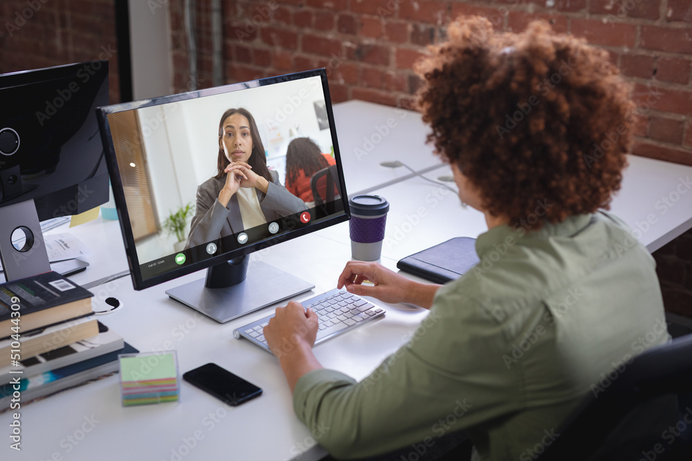 Biracial businessman and african american businesswoman having online meeting through desktop pc