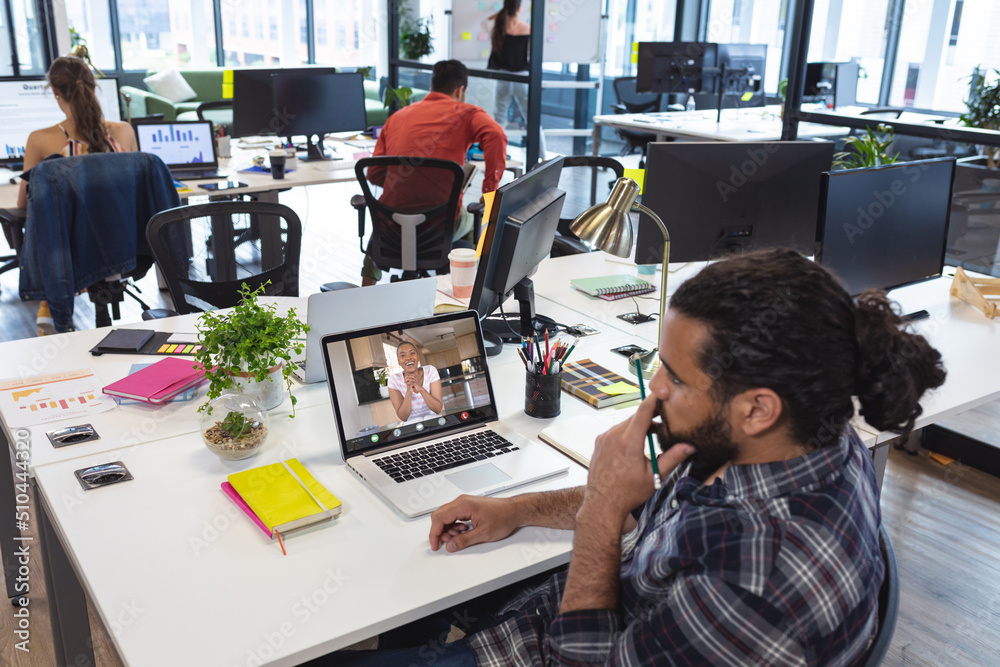 African american businessman and businesswoman sharing ideas while having online meeting in office