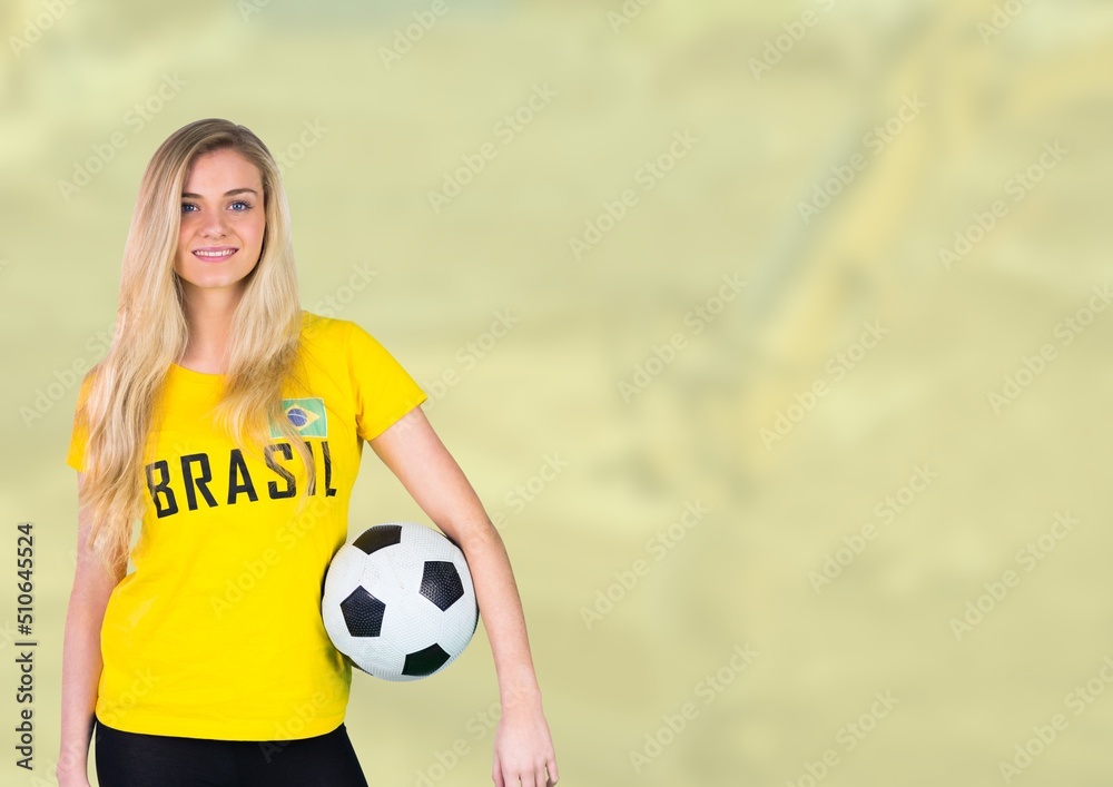 Composite image of caucasian woman holding soccer ball against blurred background with copy space